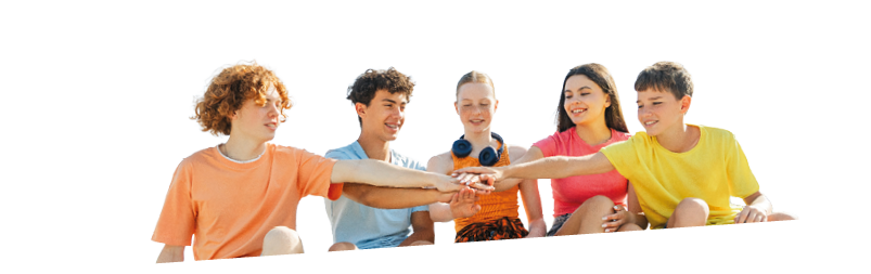 Excited multiracial friends, teenagers connecting hands, demonstrating spirit of friendship, sitting outdoors. Happy stylish boys and girls communication on the street. Positive lifestyle, summer